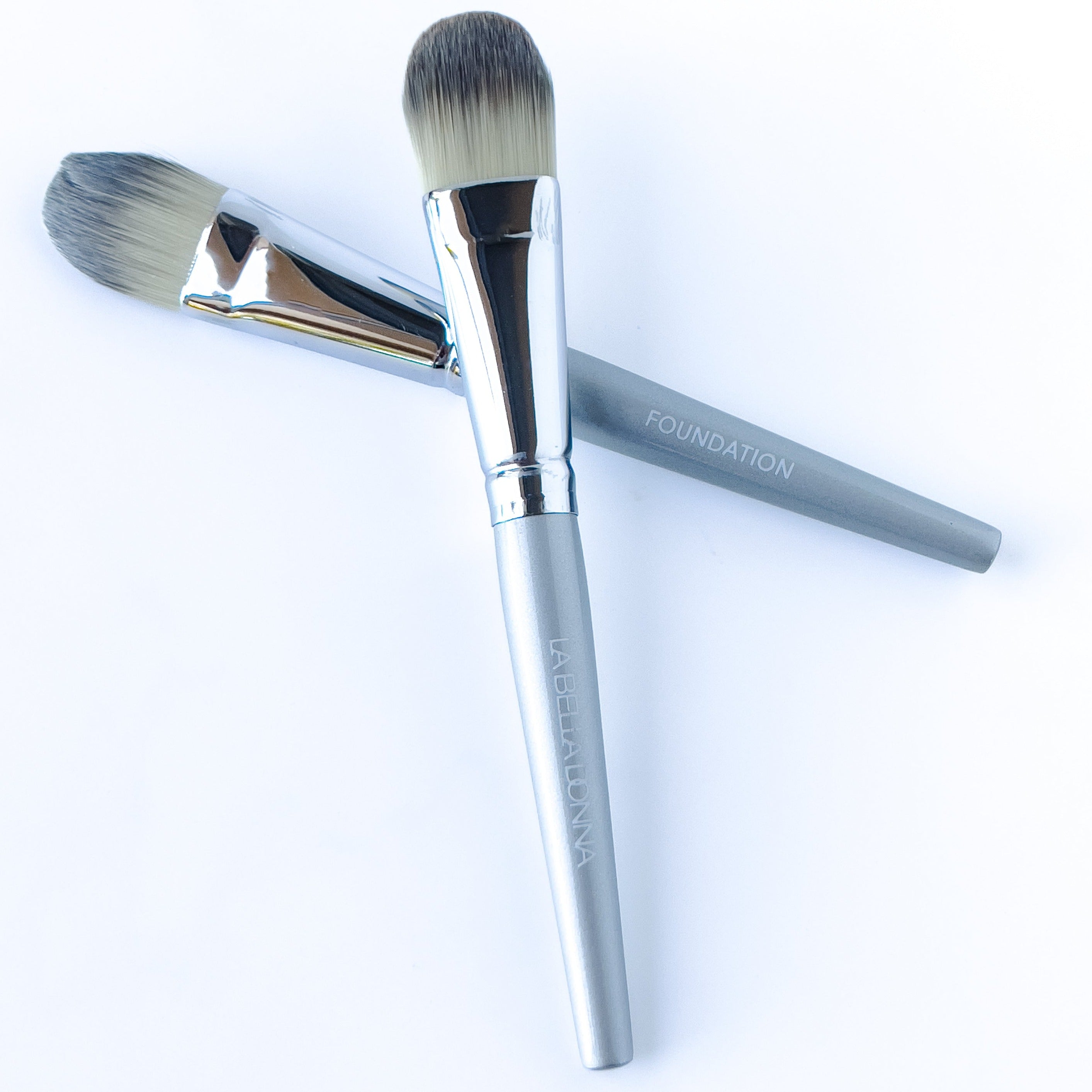 Two medium application brushes are shown. The handle is metal towards the medium brush tip with a gray handle inscribed with "La Bella Donna"