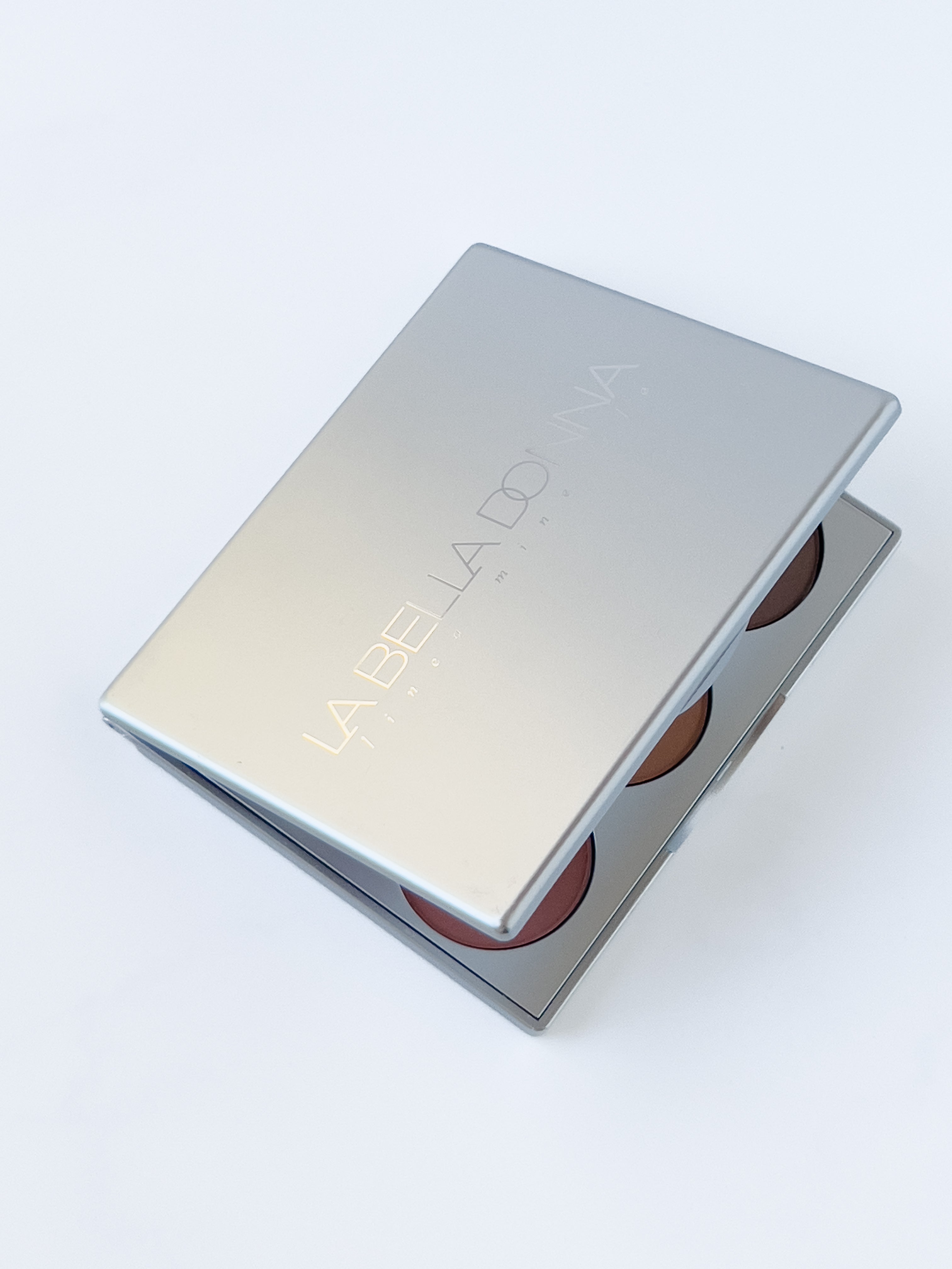Rectangular silver positano mineral makeup palette shown partially closed